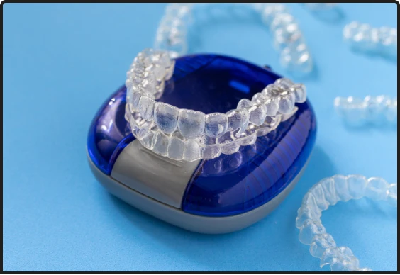 Patient holding a clear aligner tray in Playa del Carmen