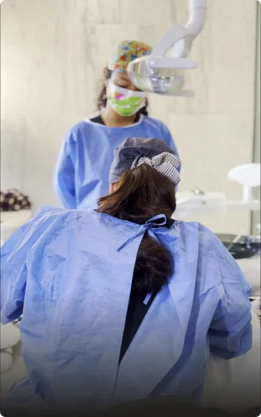 Dental implant surgery in progress under sterile conditions with the dental team.