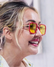 A side-profile shot of the smiling female patient, showcasing the natural fit and aesthetic appeal of her new dental crowns.