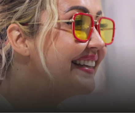 Side profile of a happy, smiling female patient showcasing her natural-looking Dental Veneers.