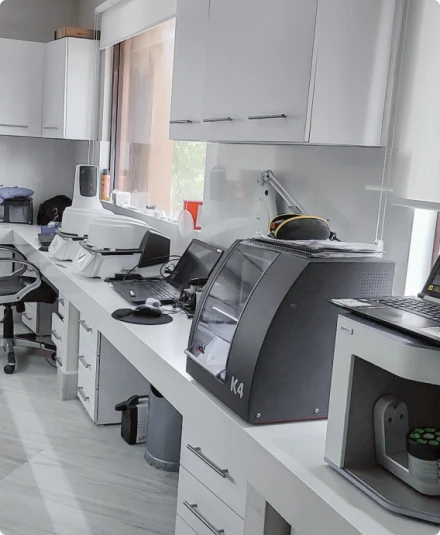 A modern and clean in-house dental laboratory equipped with advanced high-tech digital dentistry machines and technology for precise treatment fabrication.