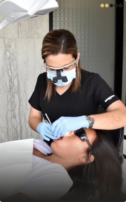 dr Alejandra Paz performing dental procedure under young woman
