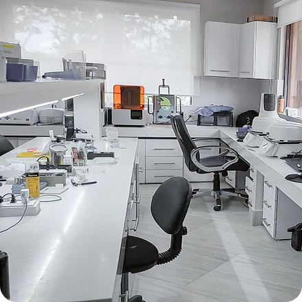 A modern, well-equipped dental laboratory and treatment planning room with high-tech equipment and a focus on digital implant technology.