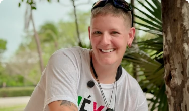 young man with perfect smile showcasing the results after getting his teeth done in Smile Makeover