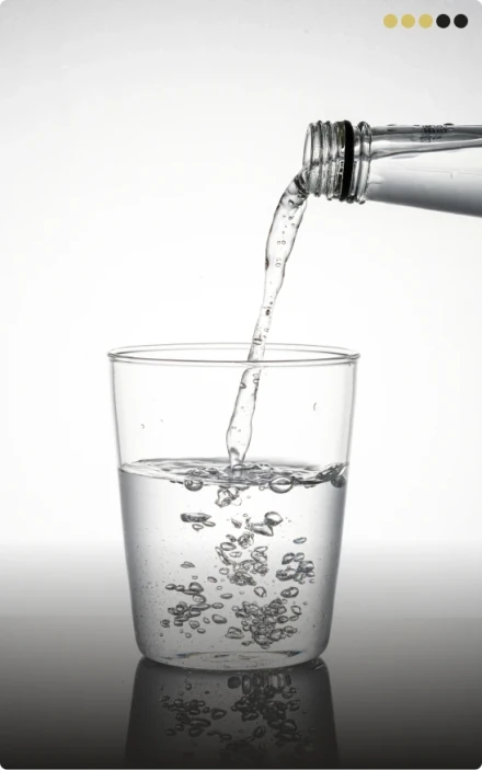 Milk being poured into a mason jar of iced coffee, lightening the dark beverage, illustrating beverage modifications to consider during a dental white diet.