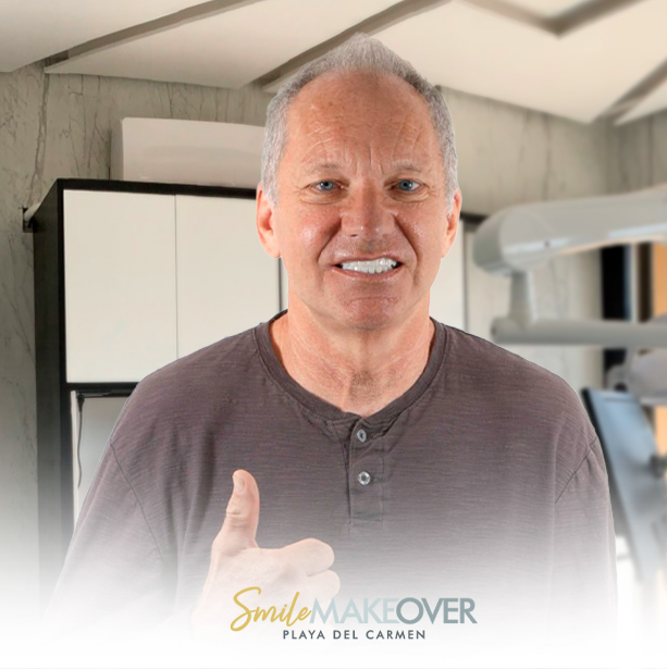 smiling man giving a thumbs-up sign, showcasing his dental treatment results