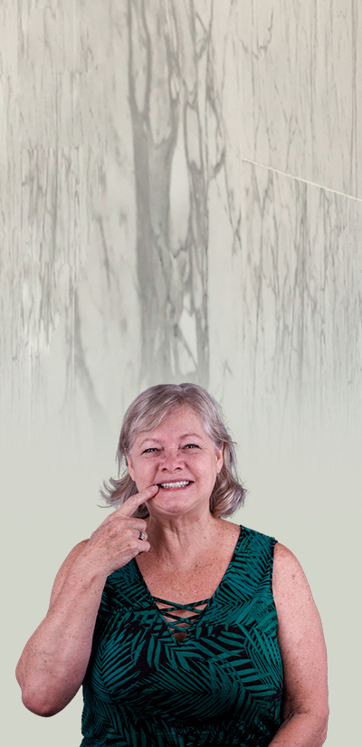 patient smiling after getting dentures in playa del carmen